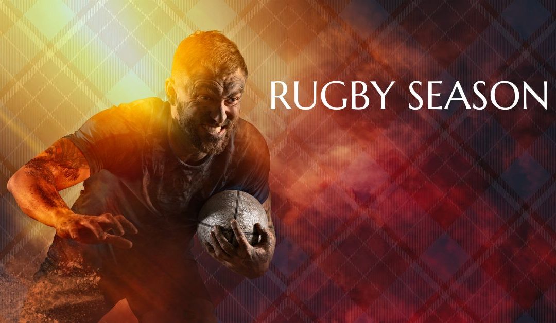 Rugby player with gritted teeth holding the ball against a firey background with a faint tartan print with the words - RUGBY SEASON