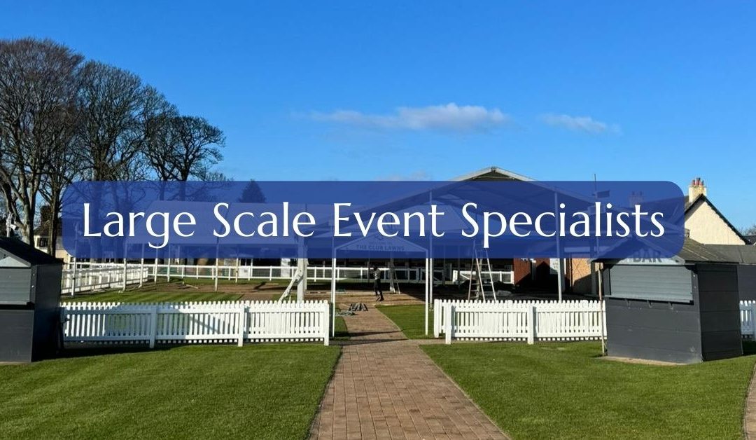 Outdoor event scene, blue skies, green lawns - large event specialists written infront